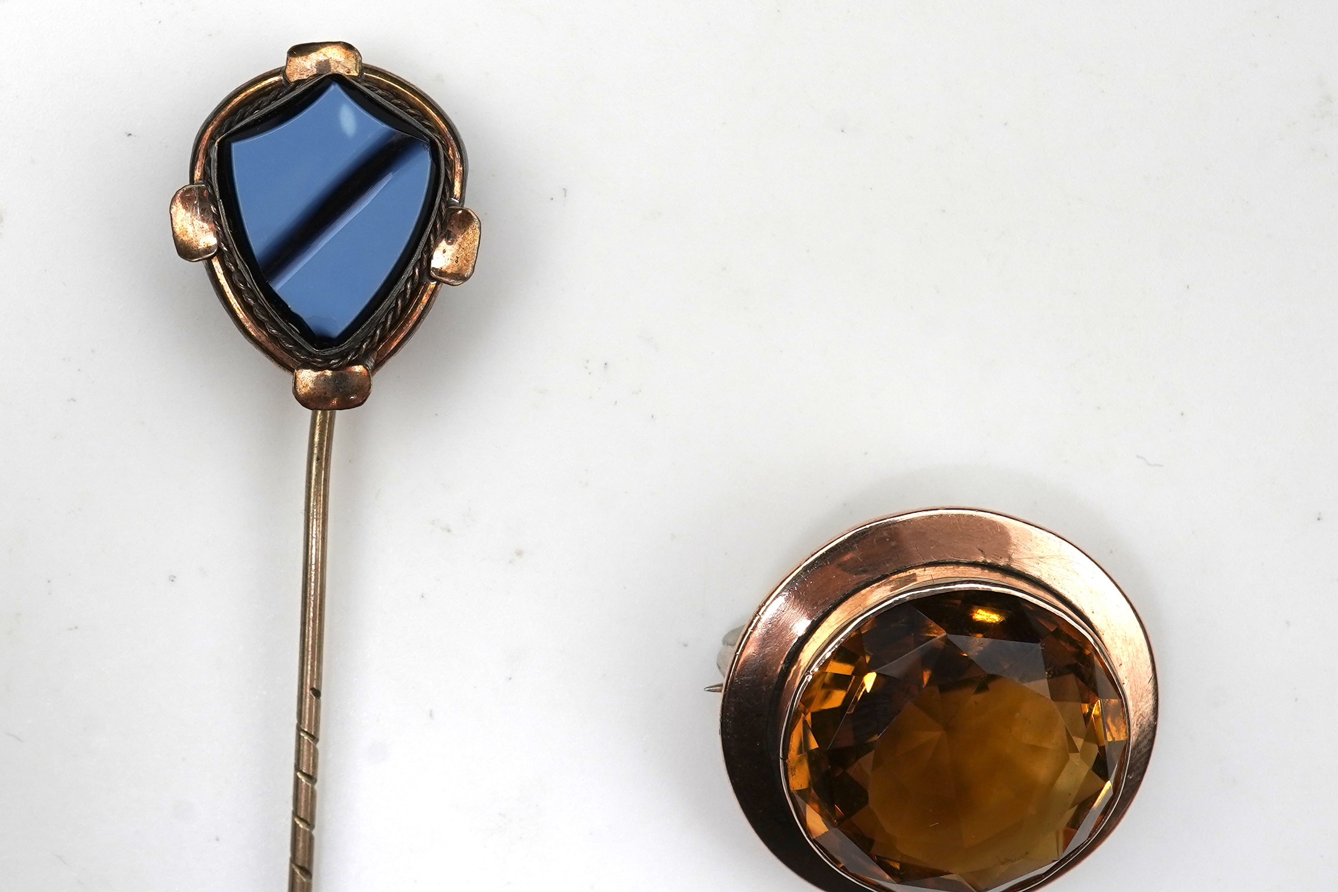 A citrine brooch and pendant, and onyx stickpin